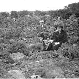 Robin Ross, Mrs McLean, Mrs McDonald and Jean McLean sitting in a mine crater east of Traprain.jpg